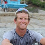 Luke Bell sitting on beach wearing Turbine